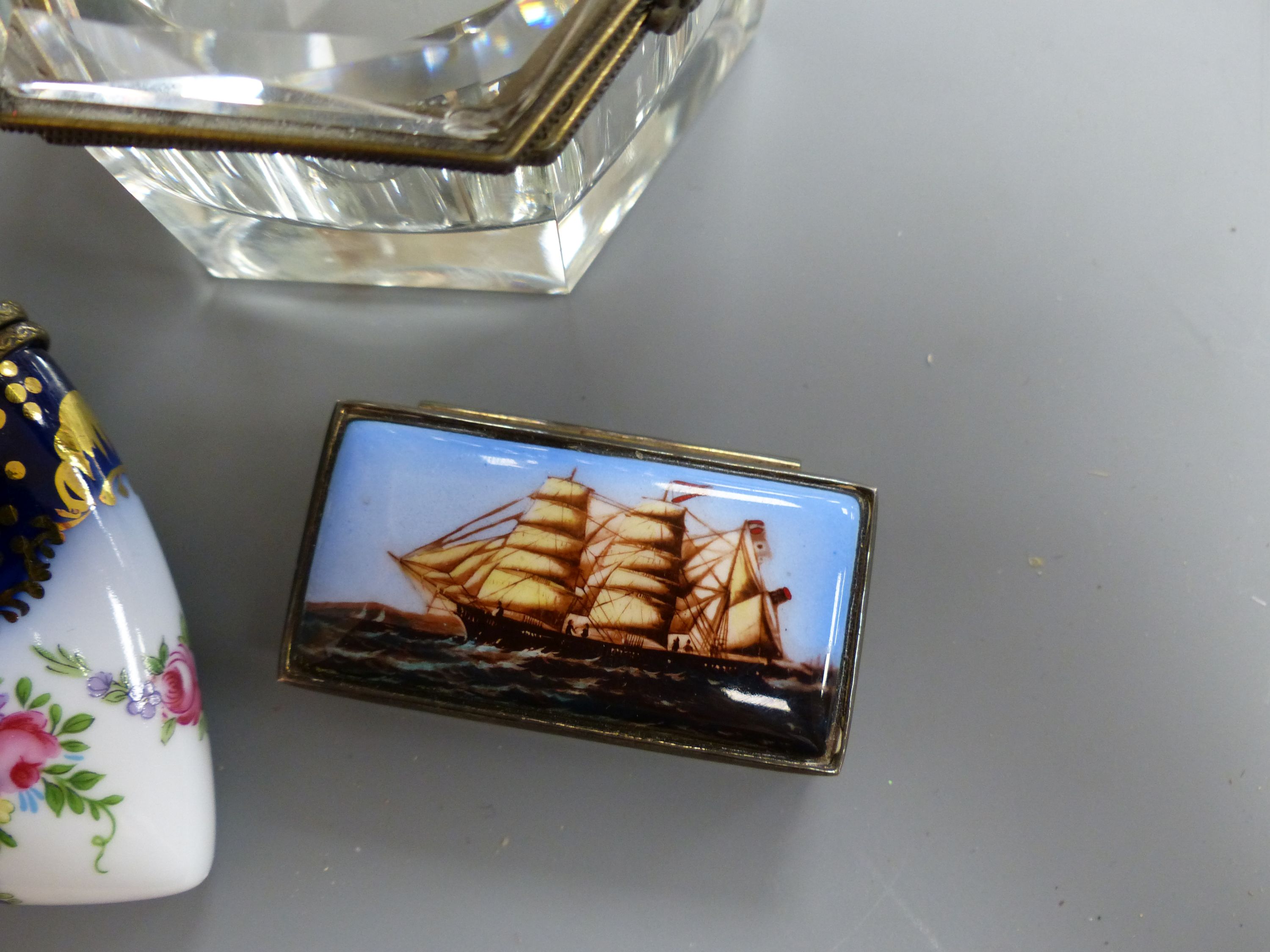 A rectangular silver snuff box, the lid with enamelled decoration of a clipper ship, a Thomas Goode bonbonniere, a Limoges bonbonniere and two other boxes